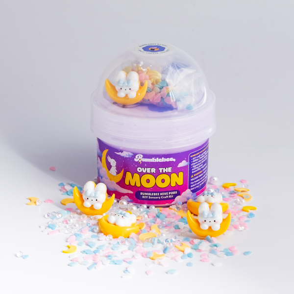 Over the Moon Hivepod with bunny-on-the-moon charms and pastel sprinkles scattered around it
