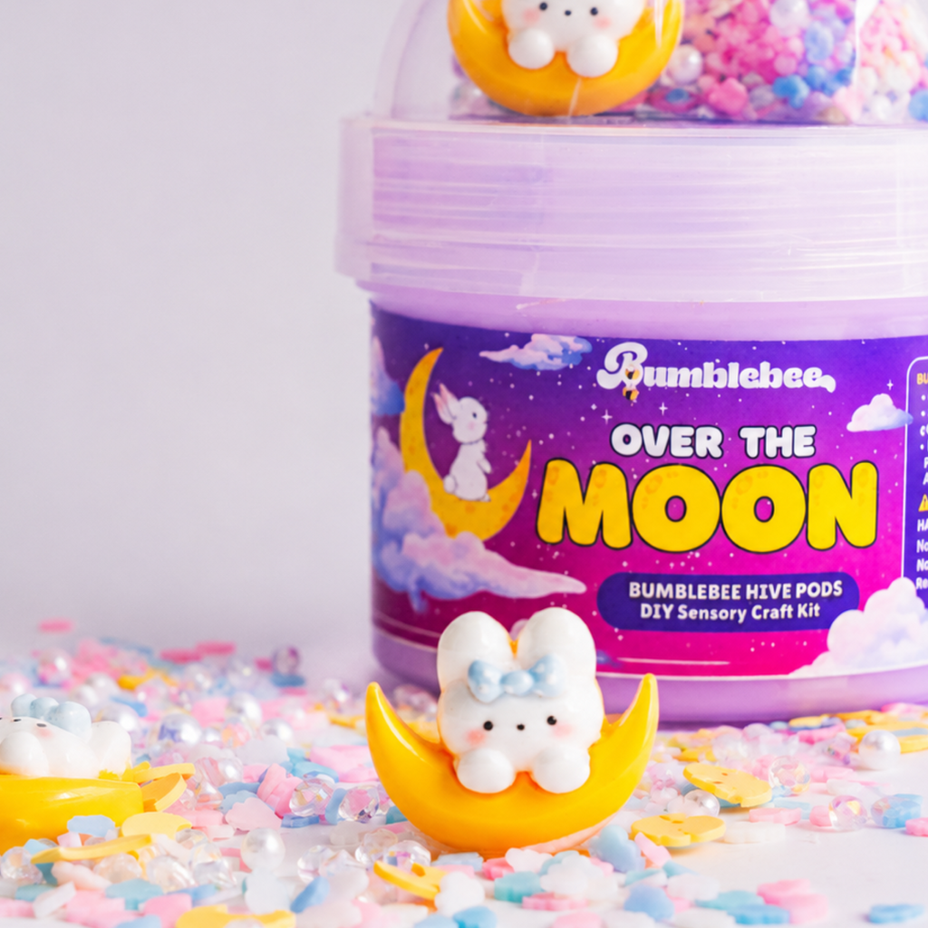 Close-up of the Over the Moon Hivepod label with a bunny-on-the-moon charm in the foreground