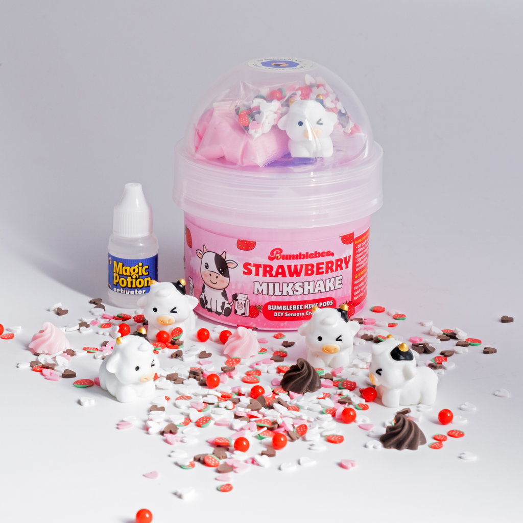 Strawberry Milkshake Hivepod with cow charms, strawberry sprinkles and an activator bottle on white