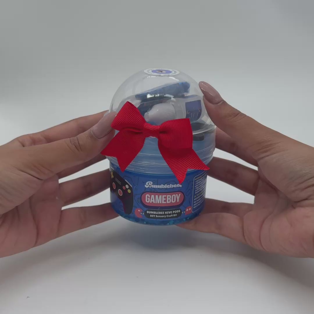 Video showing Gameboy blue clear slime being stretched with game controller charm and crunchy add-ons
