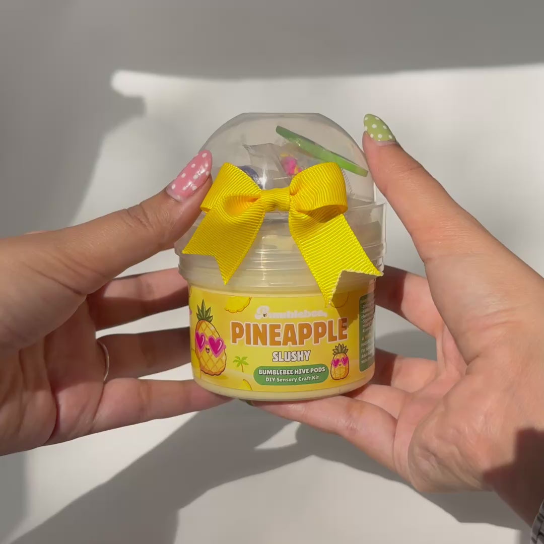 Video showing Pineapple Slushy crunchy slime being stretched and pressed with pineapple charm and crunchy add-ons