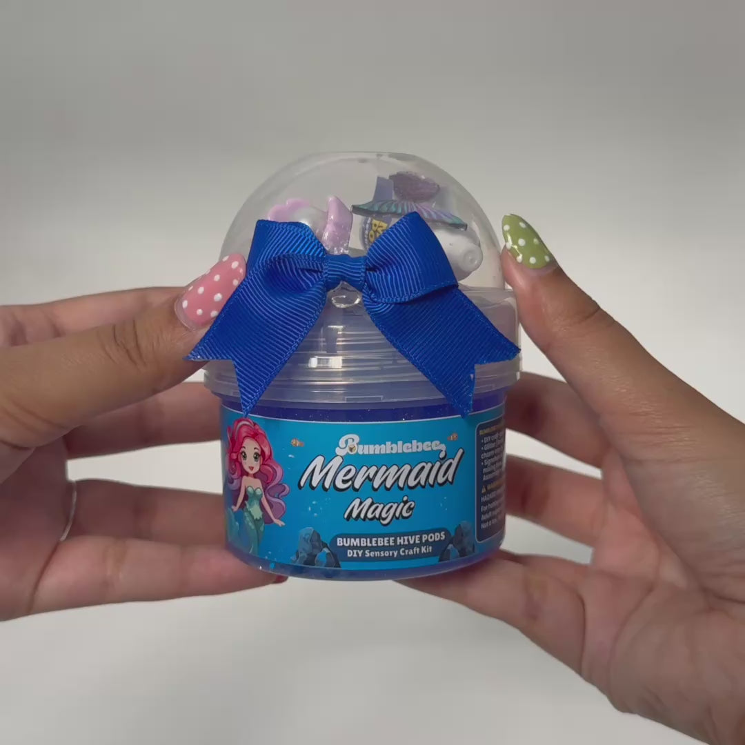 Video showing Mermaid Magic ocean slime being stretched with mermaid tail charm and sparkly add-ons