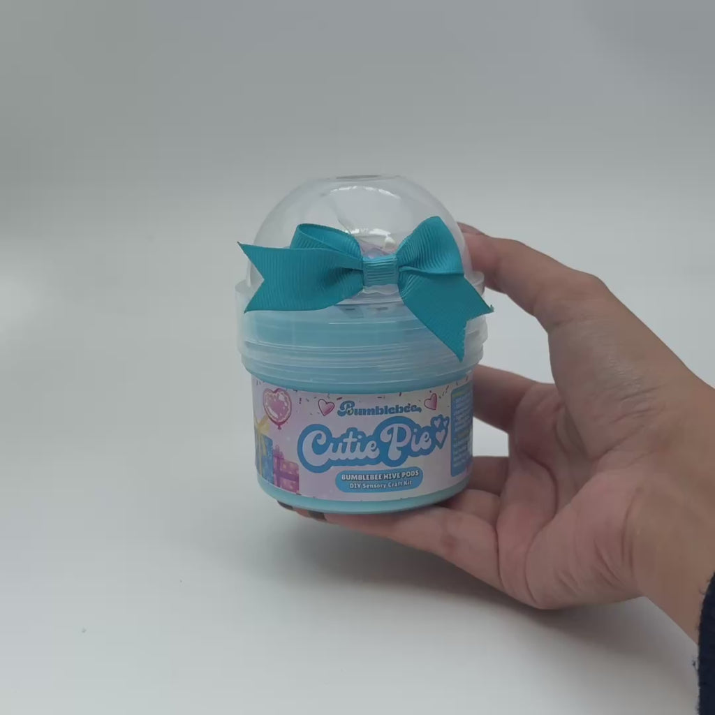 Video showing Cutie Pie smooth stretch slime Hivepod with sweetheart sprinkles and lollipop add-ons